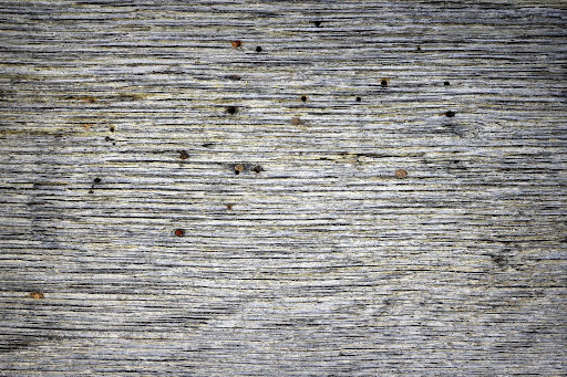 Several holes in a wooden slab